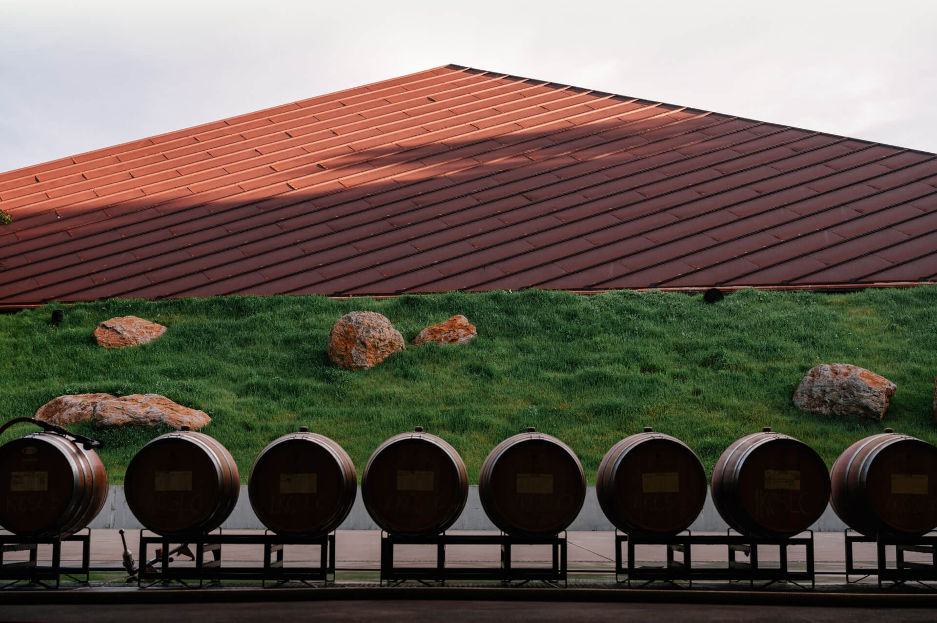 barrels in a row in front of a tile rooftop