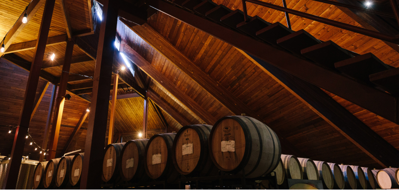 inside view with stacked barrels of wine