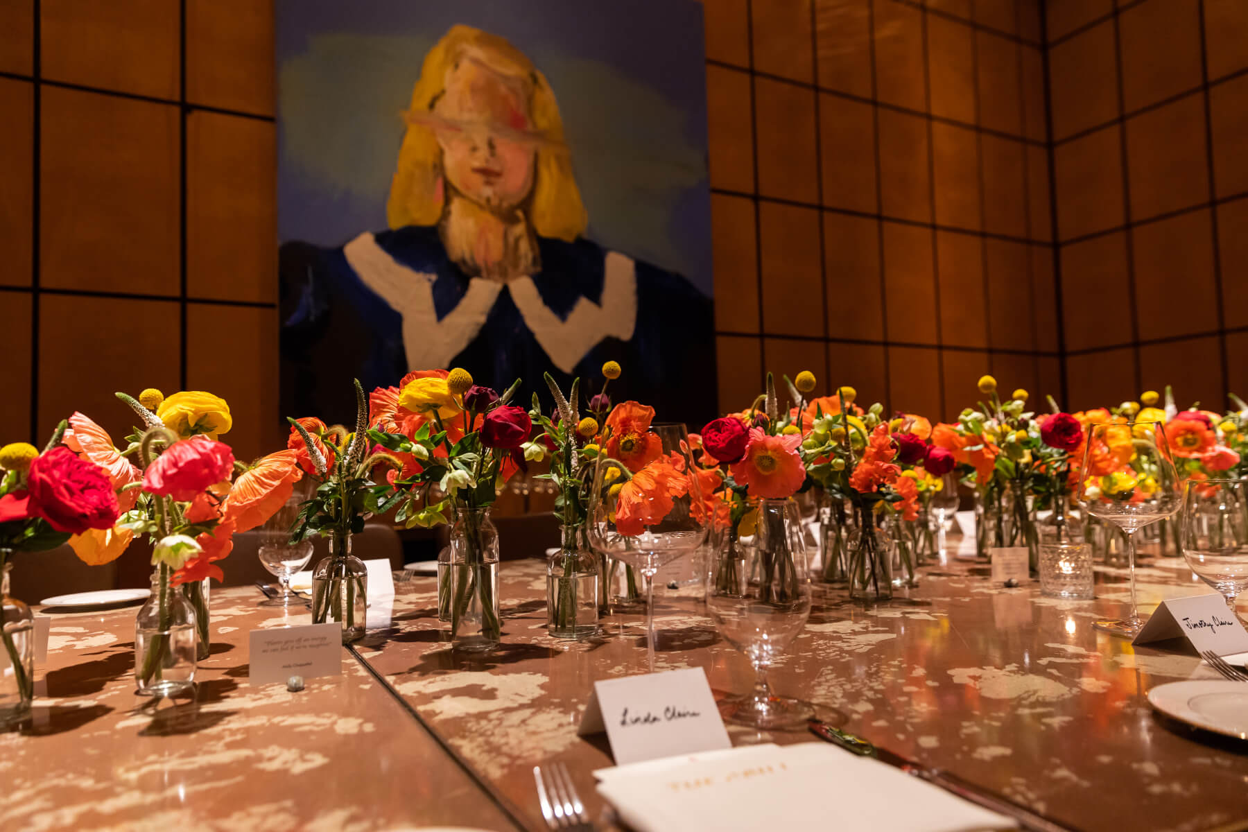 Table setting with flowers and art frame on wall