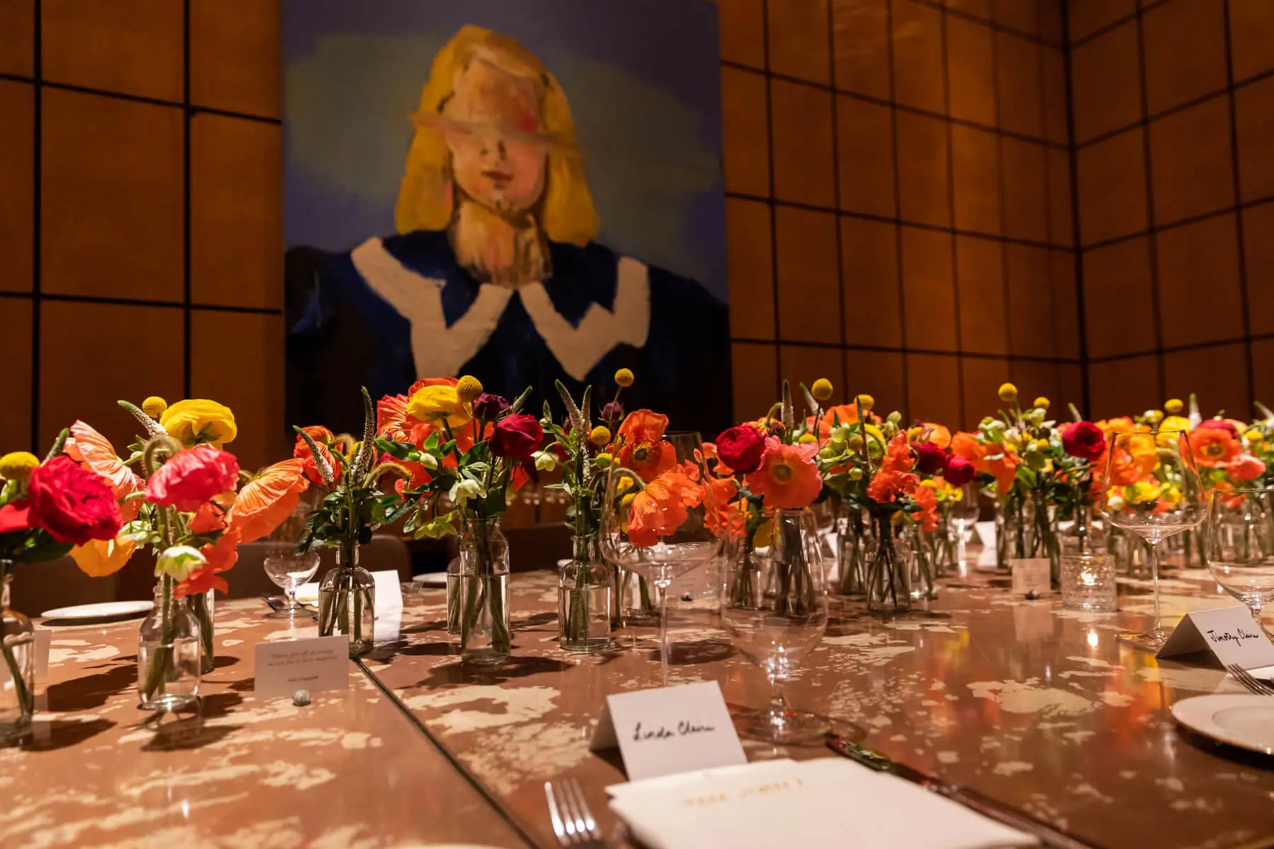 Table setting with flowers and art frame on wall