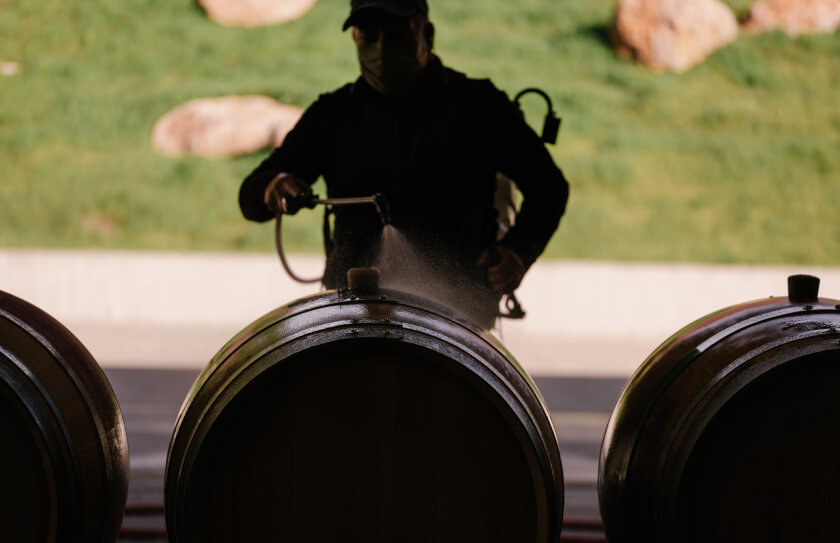 Chappellet employee washing wine barrels